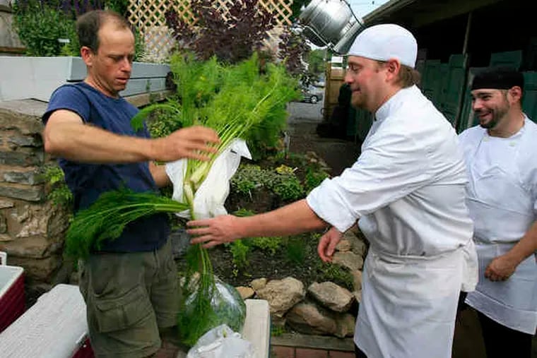 Making a delivery to Bolete, Jeffrey Frank (left) hands fresh fennel to owner Lee Chizmar, with sous chef Michael Joyce. The Bethlehem restaurant has earned national kudos and is a showcase for the region's premier farmers.