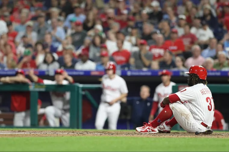 Odubel Herrera of the Phillies sits on the ground after striking out in the 8th inning against the Red Sox at Citizens Bank Park on August 14, 2018. Herrera claimed he was hit by the pitch.