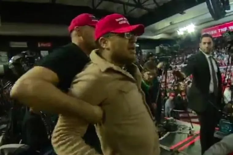 An unidentified supporter of President Trump is restrained after attacking a BBC cameraman during a campaign rally in El Paso, Texas, Monday night.