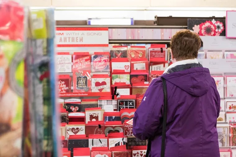 A woman shops for Valentine's Day cards at the Hallmark store at the Academy Plaza Shopping Center in Northeast Philadelphia on Friday, Feb. 2, 2018. For this year's holiday, writer Constance Garcia-Barrio recommends you ditch romance and bitterness to revel in heartache.