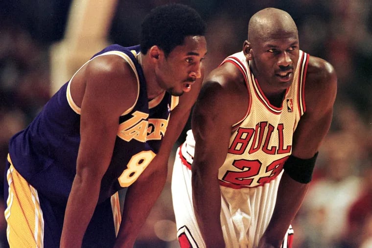 Los Angeles Lakers guard Kobe Bryant, left, and Chicago Bulls guard Michael Jordan talk during a free-throw attempt on  Dec. 17, 1997 at the United Center in Chicago.