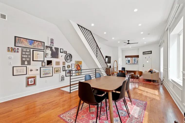 The South Philly home features hardwood floors and custom metal railings throughout.