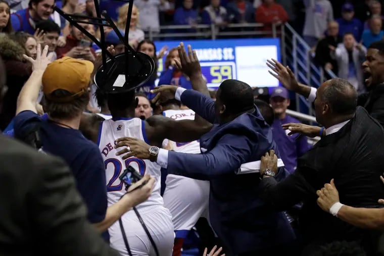 A fight between players spills into the crowd during the second half between Kansas and Kansas State.