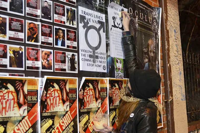 Riot's still going on: An activist posts a flier for transgender rights.