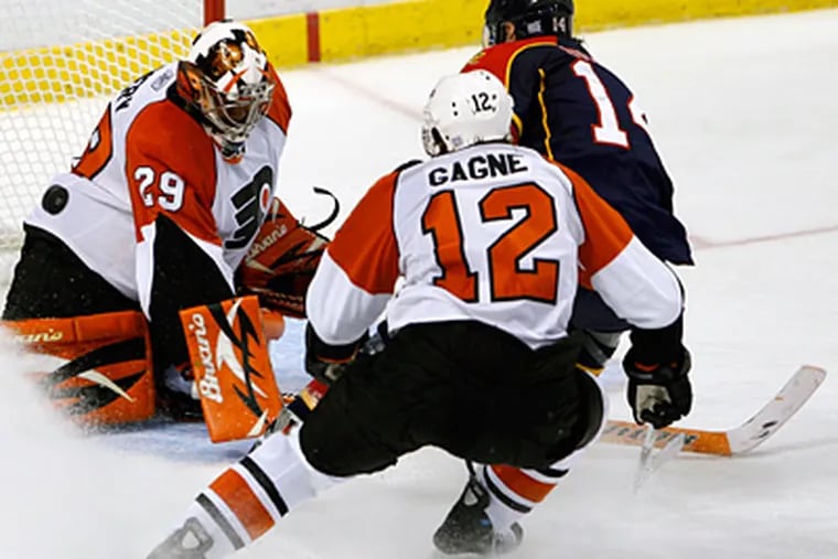 Florida Panthers right wing Radek Dvorak scores against Flyers goalie Ray Emery as he is chased by Simon Gagne during the Panthers' 4-2 win on Friday. (AP Photo/Wilfredo Lee)