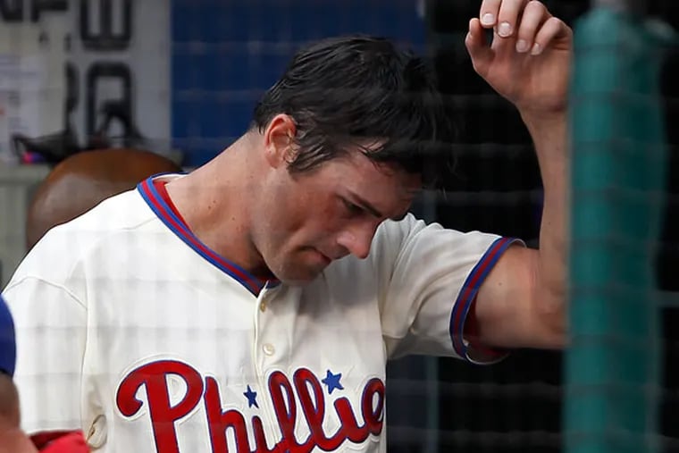 Cole Hamels walks through the dugout in the third inning. (David Maialetti/Staff Photographer)