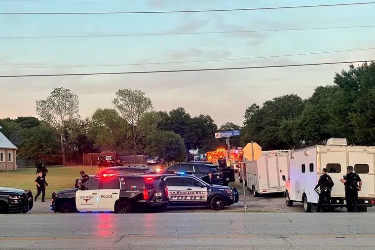Law enforcement work the scene where multiple shots were fired in Haltom City, Texas, on Saturday, July 2.