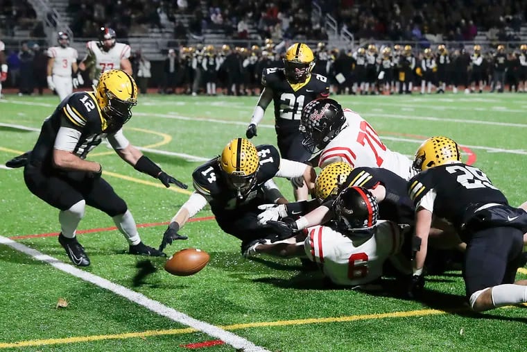 Central Bucks West High's Nick Olear (No. 14) and players from C.B. West and Coatesville scramble to recover a fumble during the District 1 Class 6A football quarterfinals on Nov. 8, 2019.