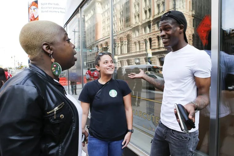 Starbucks worker Jordan Crockett (right) talks about the coffee company’s racial-bias training with Ashley Pasquarella (center) and Jaicee Huff during a break outside the Loews Hotel on Tuesday.