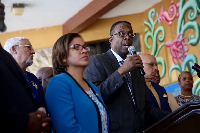 City Councilman Darrell Clarke, center, calls for legislation to ban guns at city recreation centers during a news conference at Mander Playground in Philadelphia’s Strawberry Mansion section on Wednesday, July 24, 2019. He is flanked by state Rep. Donna Bullock (D., Phila.), foreground, and state Sen. Vincent Hughes (D., Phila.).