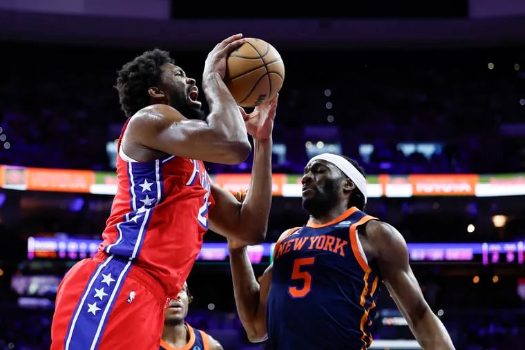 Sixers center Joel Embiid gets fouled driving to the basket against New York Knicks forward Precious Achiuwa in the second quarter of Game 4.