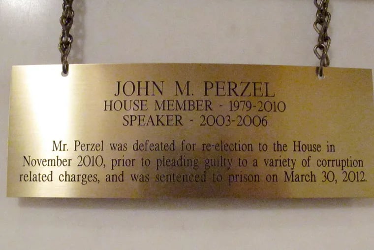 The plaque hanging in the Pennsylvania Capitol below the official portrait of former House Speaker John Perzel and three other former top state lawmakers in Harrisburg, Pa., now includes information about their criminal histories. Plaques that add those details to the dates the four men served were hung Tuesday, July 15, 2014.  (AP Photo/Marc Levy)