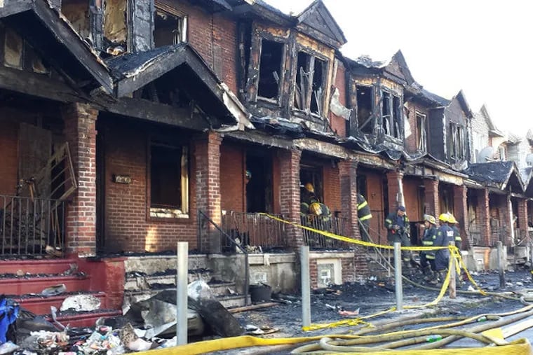 The scene from a fire in West Philadelphia this morning that killed four children as it swept through a series of rowhouses. (Rob Tornoe / Staff)