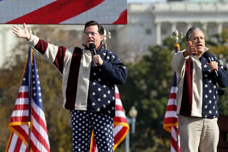 Comedians Stephen Colbert, left, and Jon Stewart perform during their Rally to Restore Sanity and/or Fear on the National Mall in Washington, Saturday, Oct. 30. (AP Photo/Carolyn Kaster)