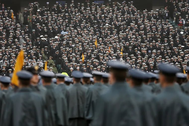 Navy midshipmen watch from the stands as Army cadets march on the field before the 120th Army-Navy game at Lincoln Financial Field in South Philadelphia on Saturday, Dec. 14, 2019.
