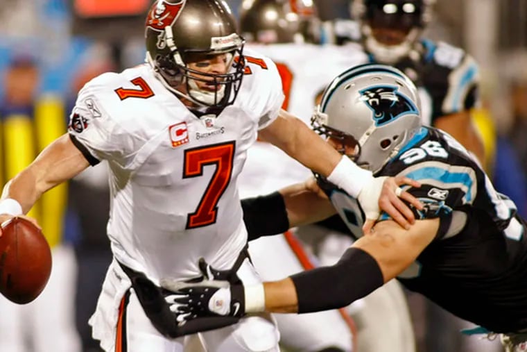 The Buccaneers&#0039; Jeff Garcia is sacked by the Panthers&#0039; Tyler Brayton during the first quarter of last night&#0039;s game, which ended too late for this edition. Carolina led, 10-3, at the half.