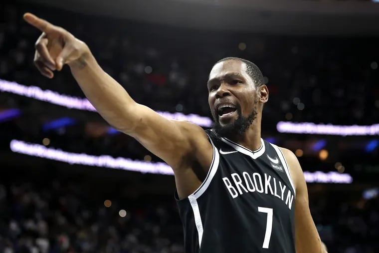 The Brooklyn Nets' Kevin Durant trades good-natured barbs with Sixers fans during a game at the Wells Fargo Center on Oct. 22, 2021.