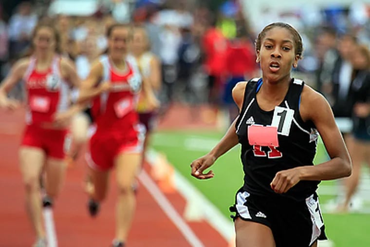 Michelle Hall is finishes first in the girls 800 meter Group 2 run event final. (Akira Suwa / Staff Photographer)