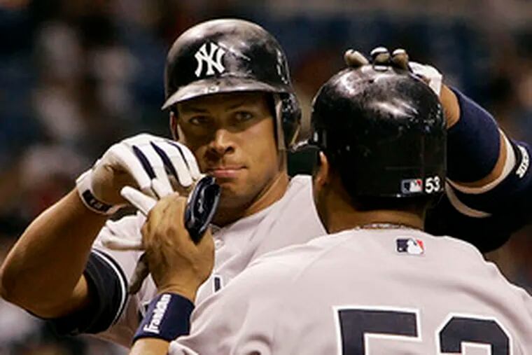 Alex Rodriguez (left) is congratulated by Bobby Abreu after ninth-inning homer vs. Tampa Bay.