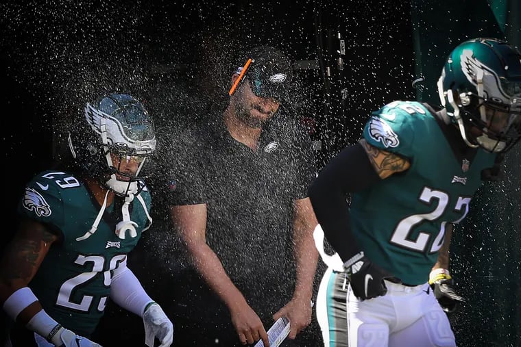Eagles coach Nick Sirianni tries to dodge the theatrical smoke in the tunnel before his team played the San Francisco 49ers on Sunday.