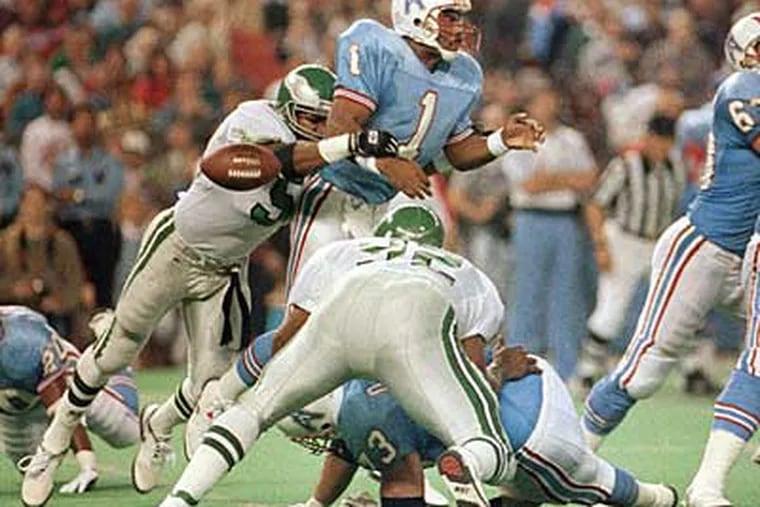 The Eagles' Seth Joyner strips Oilers QB Warren Moon and forces a fumble during a Monday night game in 1991. (Donna Carson/AP Photo)