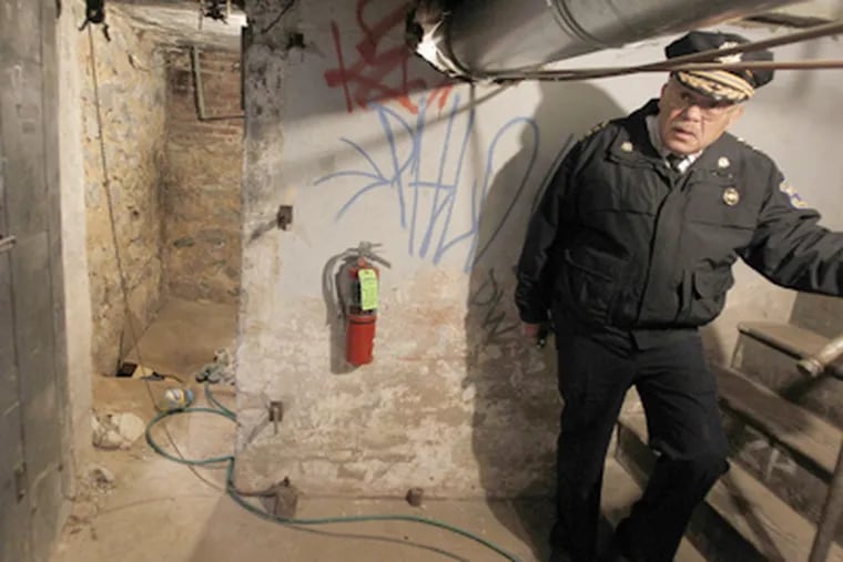 Police Commissioner Charles H. Ramsey in the Tacony subbasement where four undernourished adults were held. (Ron Cortes / Staff Photographer)