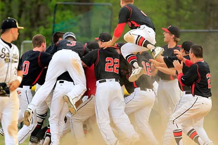 The Germantown Academy team swarm around Ryan Dolan after he drove in the winning run in the 9th inning. (Ron Cortes/Staff Photographer)
