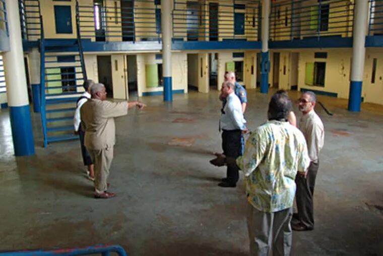 Community leaders and politicians get a tour of the now-closed Riverfront State Prison in Camden. Here, the tour is inside one of the cellblocks where the prisoners were housed. ( Clem Murray / StaffPhotographer )