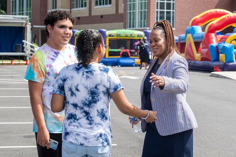 School Superintendent Katrina McCombs interacts with students Kyri Rembert and Damian Irizarry, left, on Thursday, August 11, 2022., during a school fair at Camden High School in Camden, N.J.