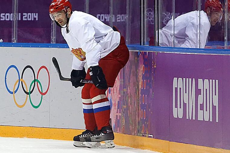 Russia forward Alexander Popov takes a break during a training session. (Julie Jacobson/AP)