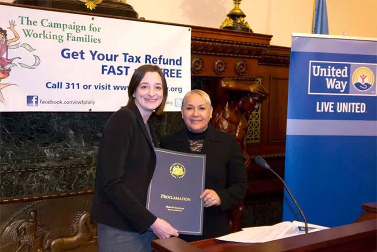 Mary Horstmann , deputy director of the Office of Policy and Planning, delivers Mayor Nutter's proclamation of Earned Income Tax Credit Day to Mary Arthur of the Campaign for Working Families.