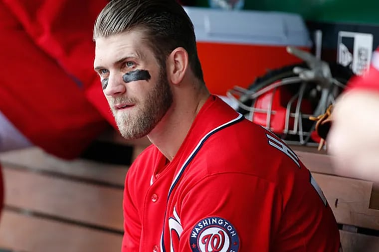 Bryce Harper sits on the bench during the fourth inning of a baseball game against the St. Louis Cardinals at Nationals Park on Saturday, April 19, 2014, in Washington. (Alex Brandon/AP)