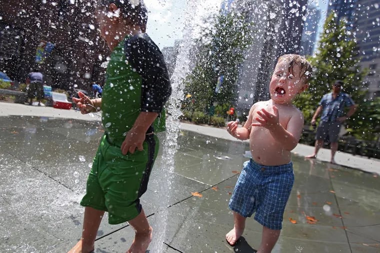 Two boys run through the fountain at Sister Cities Park in front of the Basillica of Peter and Paul in the summer of 2013. Based on the outlooks, that could become a popular activity in the coming weeks.