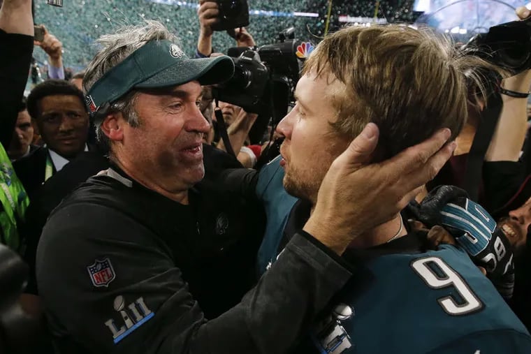 Doug Pederson (left) and Nick Foles embrace after winning Super Bowl LII on Sunday.