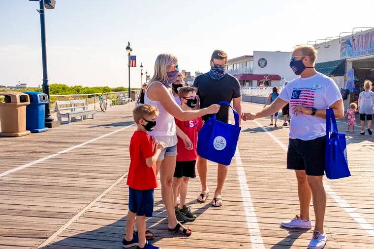 The Young family receive a gift bag from the Ocean City Public Relations team as a thank you for wearing masks in Ocean City on Saturday.