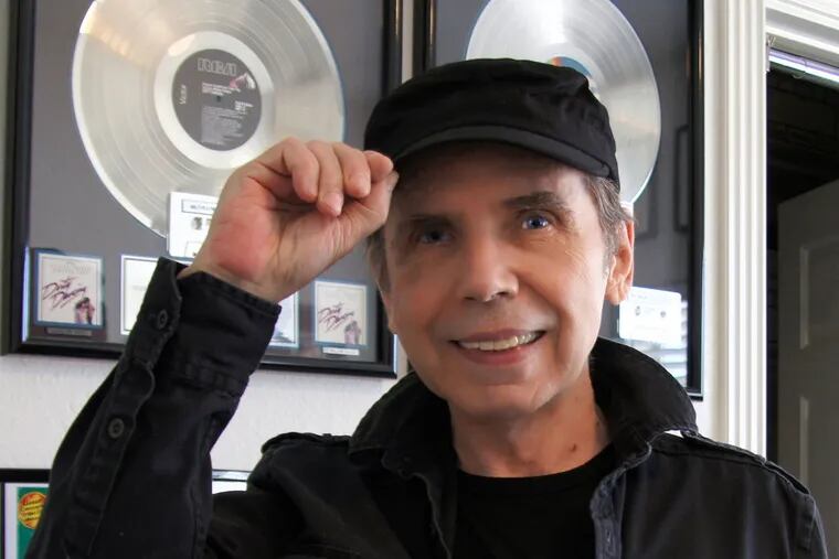 David White, who died at 79, posing before a gold record for the "Dirty Dancing" soundtrack, which included a song he co-wrote, "You Don't Own Me."
