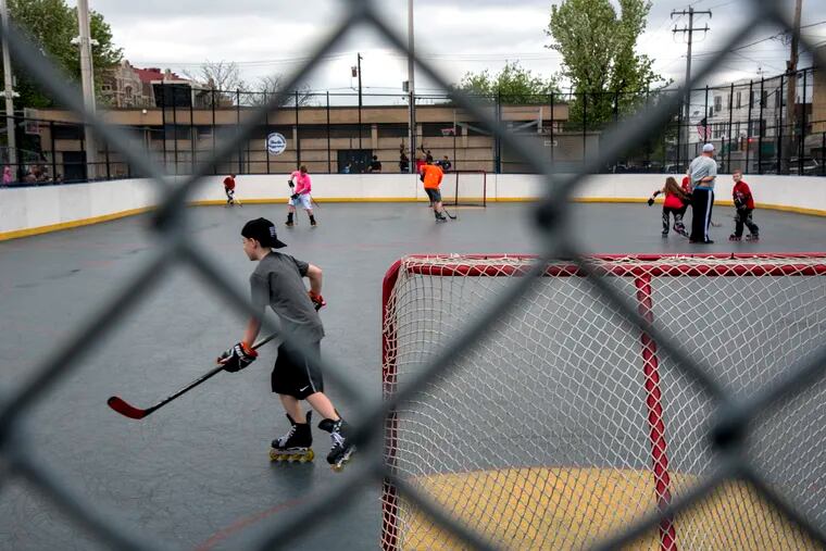 Youngsters play on the hockey rink at the Burke Playground. Since 2014, Philadelphia City Councilman Mark Squilla has directed $23,000 in public money to the Burke Community Fund, a nonprofit named for the playground.