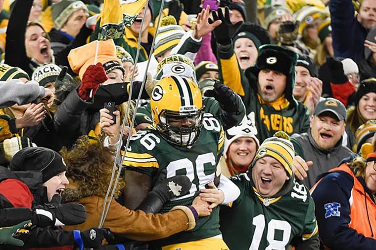 Green Bay Packers tight end Brandon Bostick (86) celebrates with fans after catching a touchdown pass in the first quarter against the Chicago Bears in Green Bay, November 9, 2014. (Benny Sieu/USA Today)