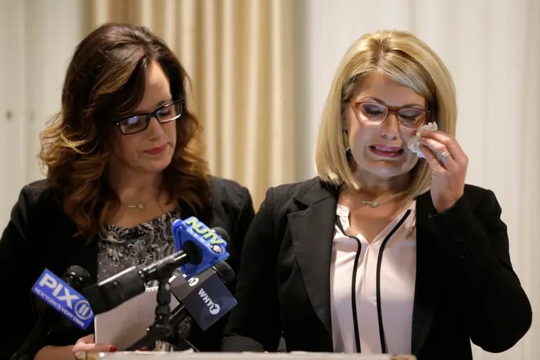As Patty Fortney-Julius (left) offers support, her sister Lara Fortney McKeever cries as she speaks to reporters during a news conference in Newark. The two sisters from Pennsylvania are suing the Archdiocese of Newark and the Diocese of Harrisburg. They allege clergy in Newark knew a priest had sexually abused children before he moved to Harrisburg and abused them and their sisters for years.