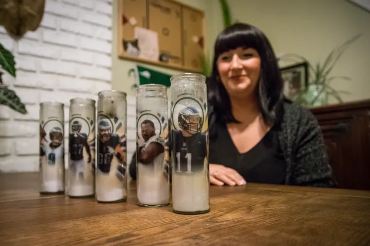 Stephanie Ricci at her Philadelphia home with the Eagles prayer candles she designs – and lights for good luck when the Birds play.