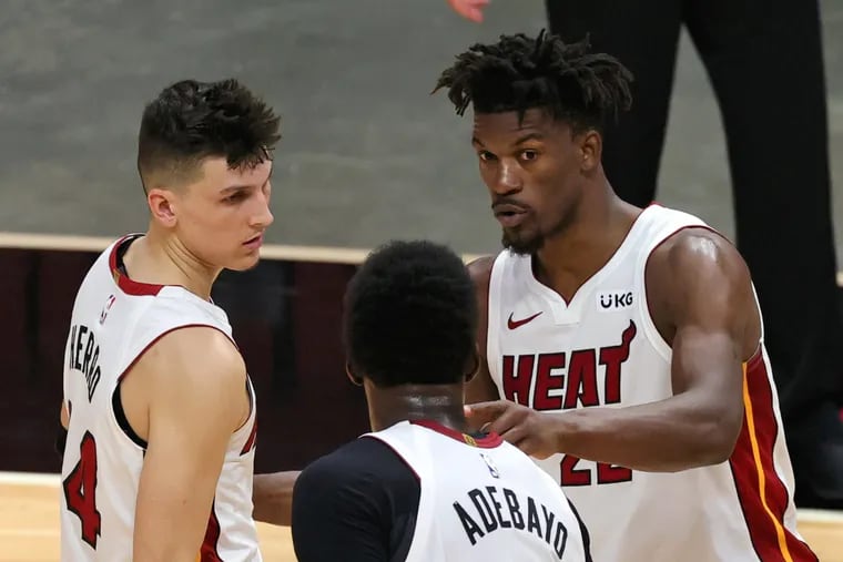 Miami Heat forward Jimmy Butler (22) talks with teammates Bam Adebayo (13) and Tyler Herro during overtime of their game against the Indiana Pacers.