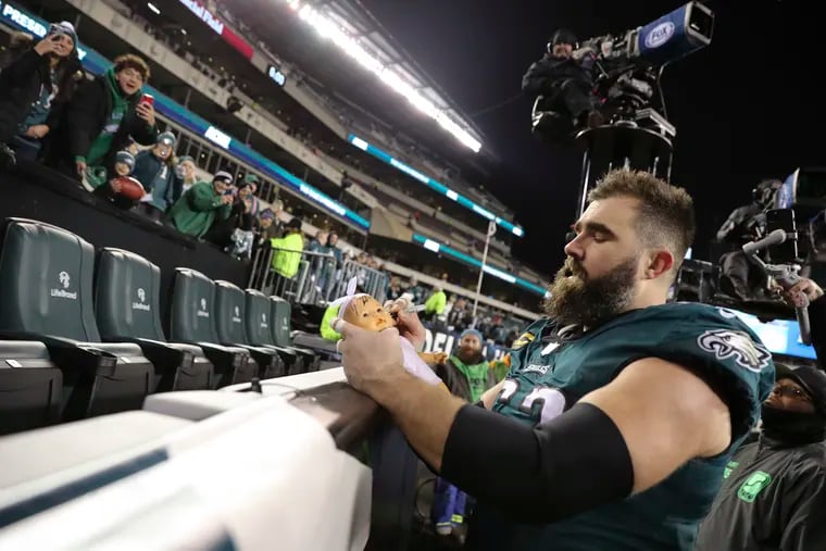 Philadelphia Eagles center Jason Kelce signs a doll’s face after the Eagles beat the Giants 38-7 at Lincoln Financial Field on Saturday, Jan. 21, 2023, in Philadelphia.