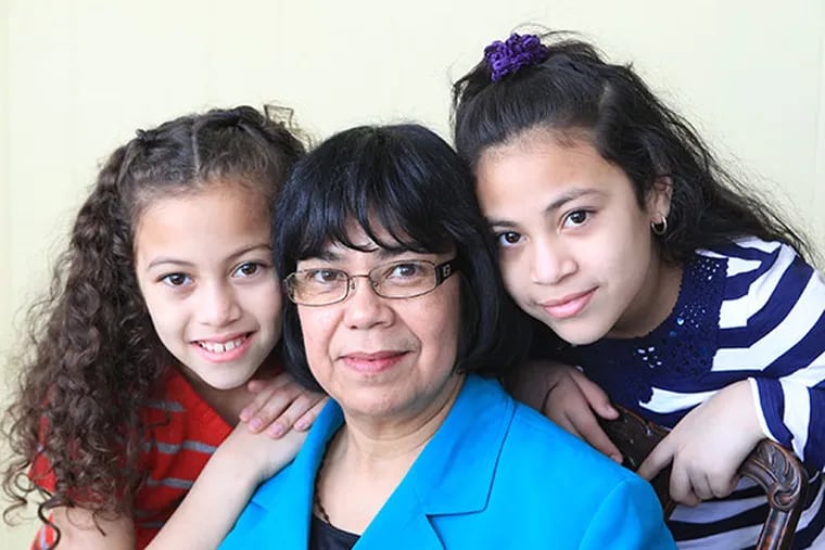 Maria Turcios, center, is shown with her granddaughters Brianna Munoz, 8, left, and Paola Munoz, 10, right, on March 9, 2014.  ( CHARLES FOX / Staff Photographer )