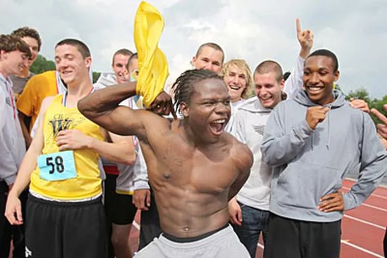 Rashaad Williams pulls off his shirt as members of the
Central Bucks West track team celebrate. (Charles Fox/Staff Photographer)