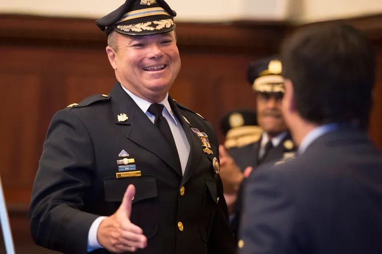 Police Chief Inspector Joseph Sullivan shakes hands with Philadelphia Managing Director Michael DiBerardinis at a City Hall ceremony on Tuesday. Sullivan received the Richardson Dilworth Award for Distinguished Public Service.
