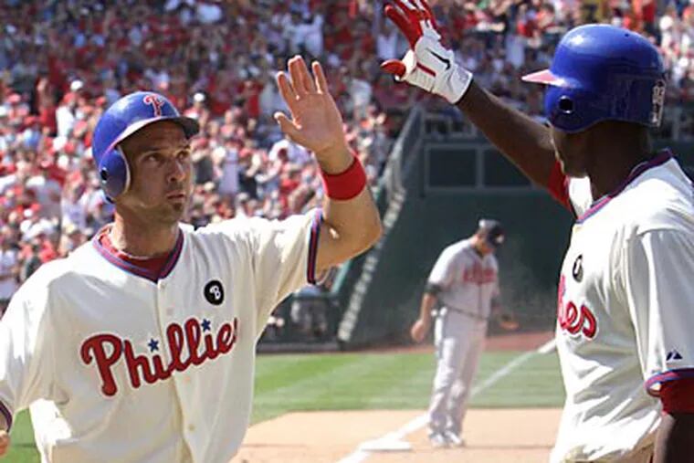 John Mayberry Jr. greets Raul Ibanez after Ibanez scored during the Phillies' 14-1 win. (David Swanson/Staff Photographer)