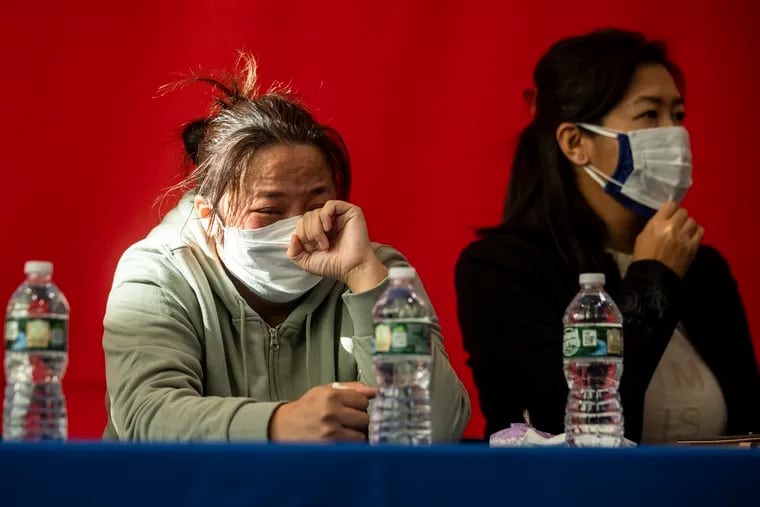 The mother of the student is in tears as speakers including John W. Chin, Executive Director of Philadelphia Chinatown Development Coropration, U.S. Rep. Dwight Evans, and Mei Lu, the victim's aunt, talk about the attack of an Asian American high school student on SEPTA at a news conference at the Crane Community Center.