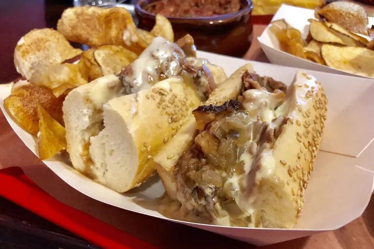 The cheesesteak at Mike's BBQ in South Philly pairs slow-smoked brisket with onions and a creamy house cheese whiz.