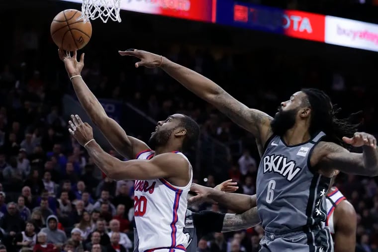 Sixers guard Alec Burks drives past Brooklyn Nets center DeAndre Jordan for a layup during the fourth quarter.
