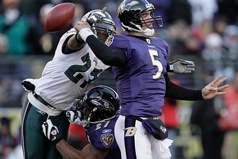Then-rookie Ravens quarterback Joe Flacco's attempt at a pass is rudely interrupted by Quintin Mikell in a 2008 game against the Eagles.